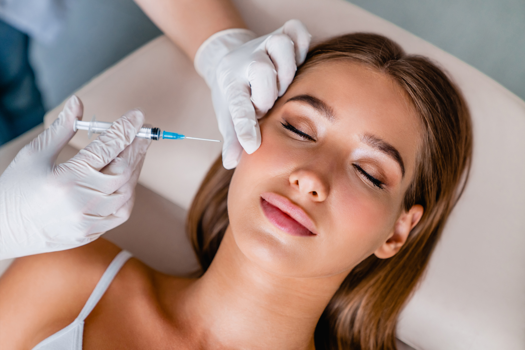 A woman receiving a rejuvenating facial treatment for glowing skin.